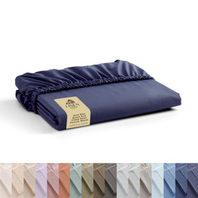 Linen Home dark blue percale fitted sheet on queen bed with a 16-inch deep pocket.
