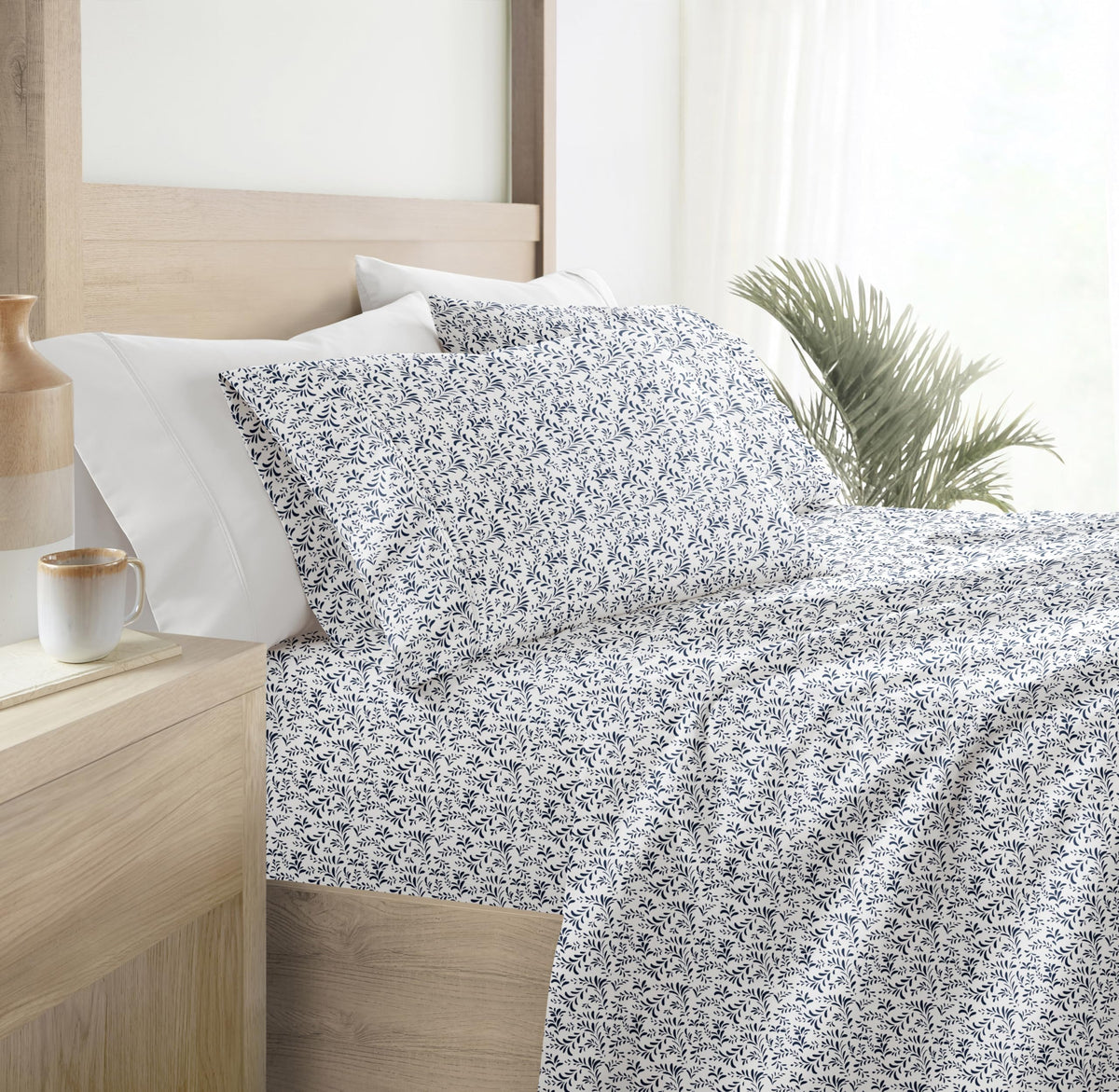 Linen Market Burst of Vines Navy pattern on bed in a cozy setup