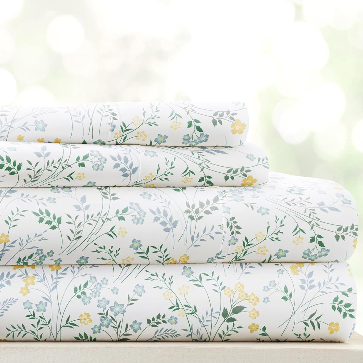 Linen Market patterned microfiber queen sheet set in wildflower light blue folded, inviting cozy aesthetic.