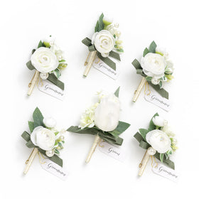 Ling's Moment boutonniere for men with ornate white ranunculus adds lasting elegance to a groom's suit