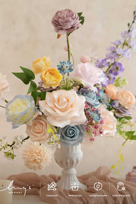 Ling's Moment powder blue and peach flowers create elegant color-coordinated centerpieces.