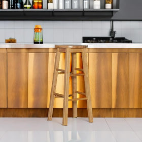 Linon 29-inch stool with four foot rails ensures stable seating.