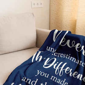 Linxher blanket draped over a sofa, a versatile cozy decor accent.