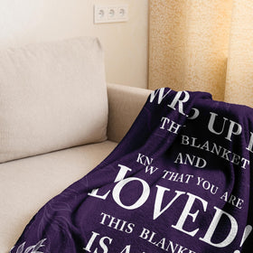 Linxher purple Love Hug throw beside travel bag for travel-friendly comfort.