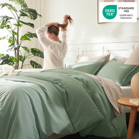 Litanika sage green bedding in a calm bedroom setting.