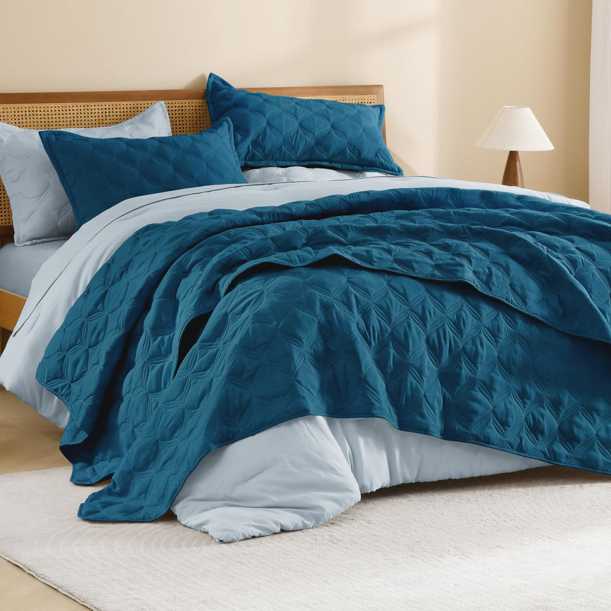Litanika king-size teal quilt on bed highlighting vibrant color and full coverage.