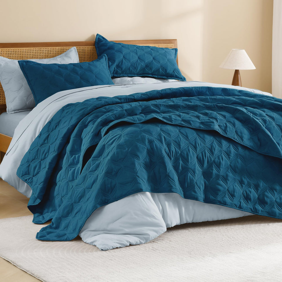 Litanika king-size teal quilt on bed highlighting vibrant color and full coverage.