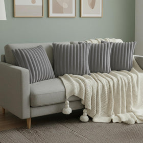 LMKLOP gray throw pillow cover on a couch, ideal accent for living spaces.