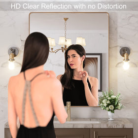 LOAAO brushed gold frame wall mirror complements modern decor.