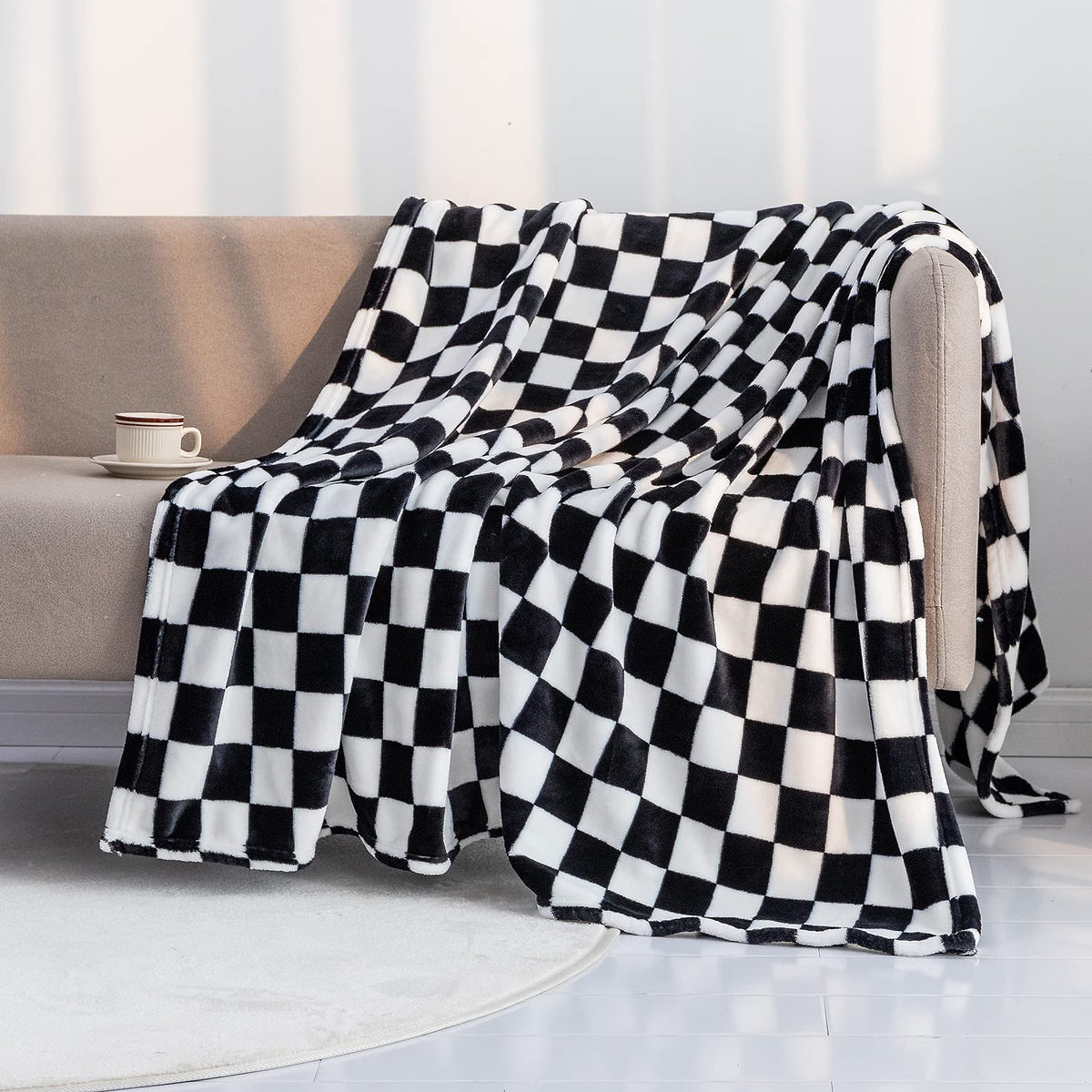 LOMAO checkerboard grid throw blanket in black on sofa for warmth and style.