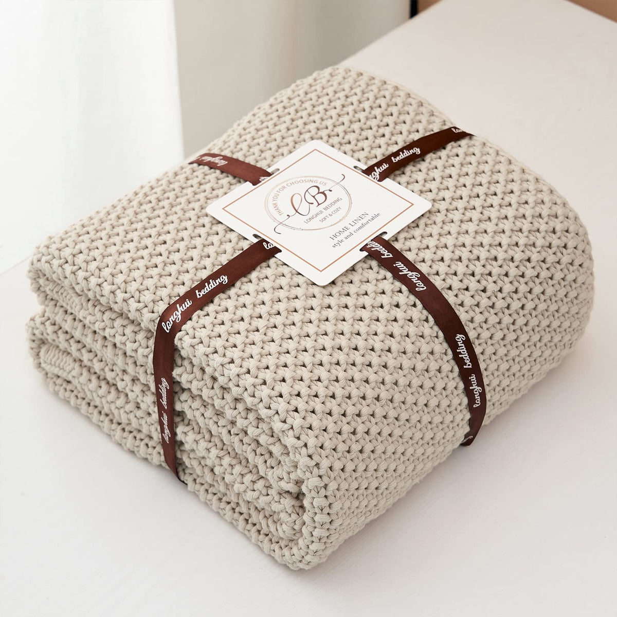 Beige Longhui Bedding throw draped over a bed for warmth and style
