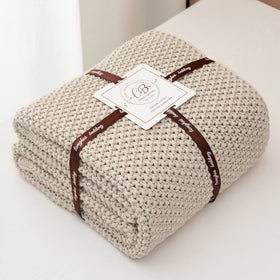 Beige Longhui Bedding throw draped over a bed for warmth and style