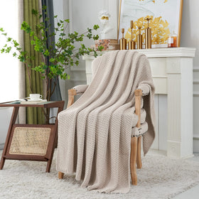 Beige Longhui Bedding throw draped over sofa, adding warmth and style.