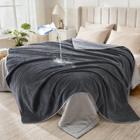LOOBANI waterproof blanket on bed or sofa with triple-layer protection.