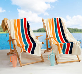 Loon & Lake retro stripes towel neatly packed in tote, ideal beach kit.