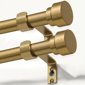 Lootkell warm gold curtain rod assembly on a window display