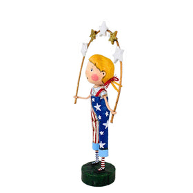 Lori Mitchell banner with stars figurine enhances patriotic shelves.