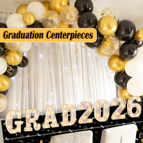Lotus Hills Grad 2026 letters on table centerpiece with warm illumination