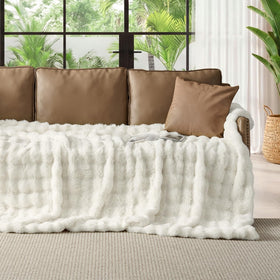 Lotus Karen bubble blanket on sofa adding luxurious texture to living room