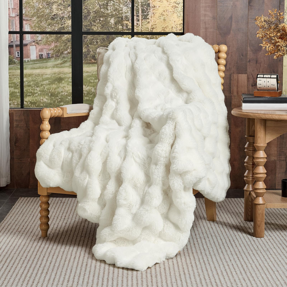 Lotus Karen cream white throw folded neatly on bed for inviting warmth
