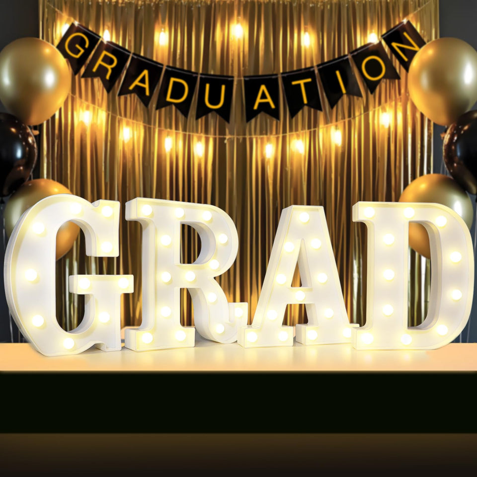 Lovelite Grad Sign wall display glow for Class of 2026 backdrop.