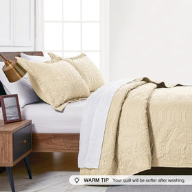 Lightweight camel bedspread layered over sheets for summer use