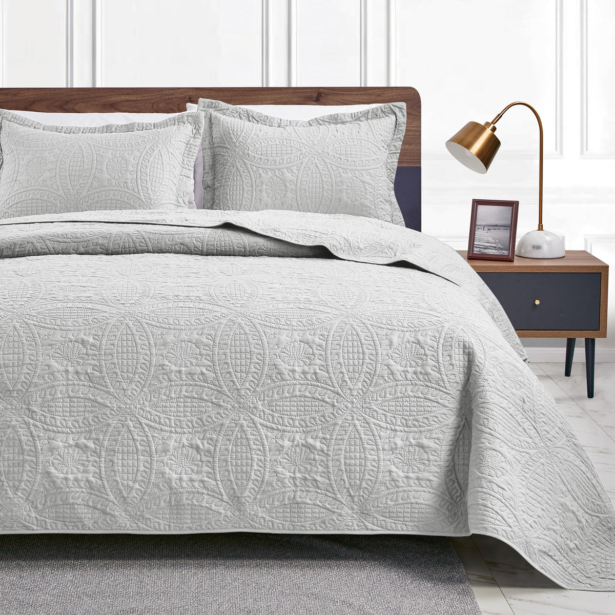 Love's cabin cal king quilt folded in light grey for easy storage and setup