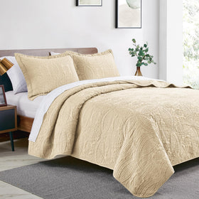 Detail of Love's cabin coin-pattern coverlet embossing for texture