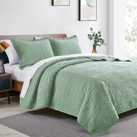 Love's cabin coin-pattern coverlet in sage enhances modern bedding aesthetic