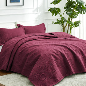 Love's cabin coin-pattern coverlet top view highlights embossed lightweight design for easy layering.