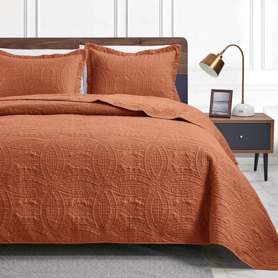 Love's cabin coin-pattern umber quilt on queen bed for year-round comfort.