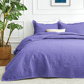 Love's cabin Deep Purple Quilt on bed delivers year-round comfort.