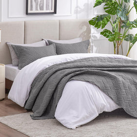 Love's cabin grey bedspread on queen bed with soft, breathable drape.