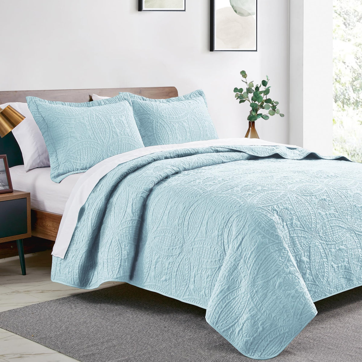 Love's cabin spa-blue quilt with pillow shams creates a coordinated, easy-care bed ensemble.