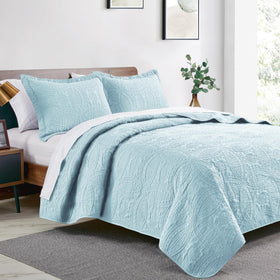 Love's cabin spa-blue quilt with pillow shams creates a coordinated, easy-care bed ensemble.
