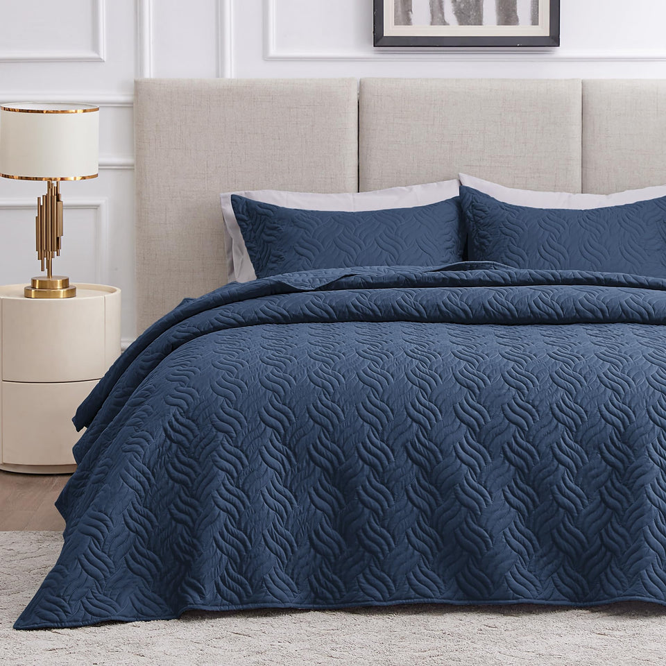 Love's cabin quilt on navy bed with wave pattern for all-season comfort