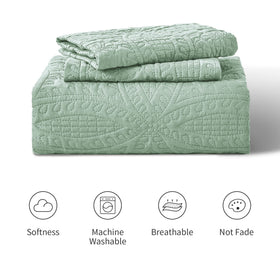 Love's cabin sage bedroom decor featuring an oversized quilt
