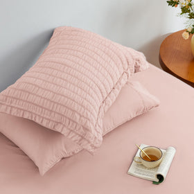 Love's Cabin Seersucker Pink pillow sham completes a cohesive bedding set