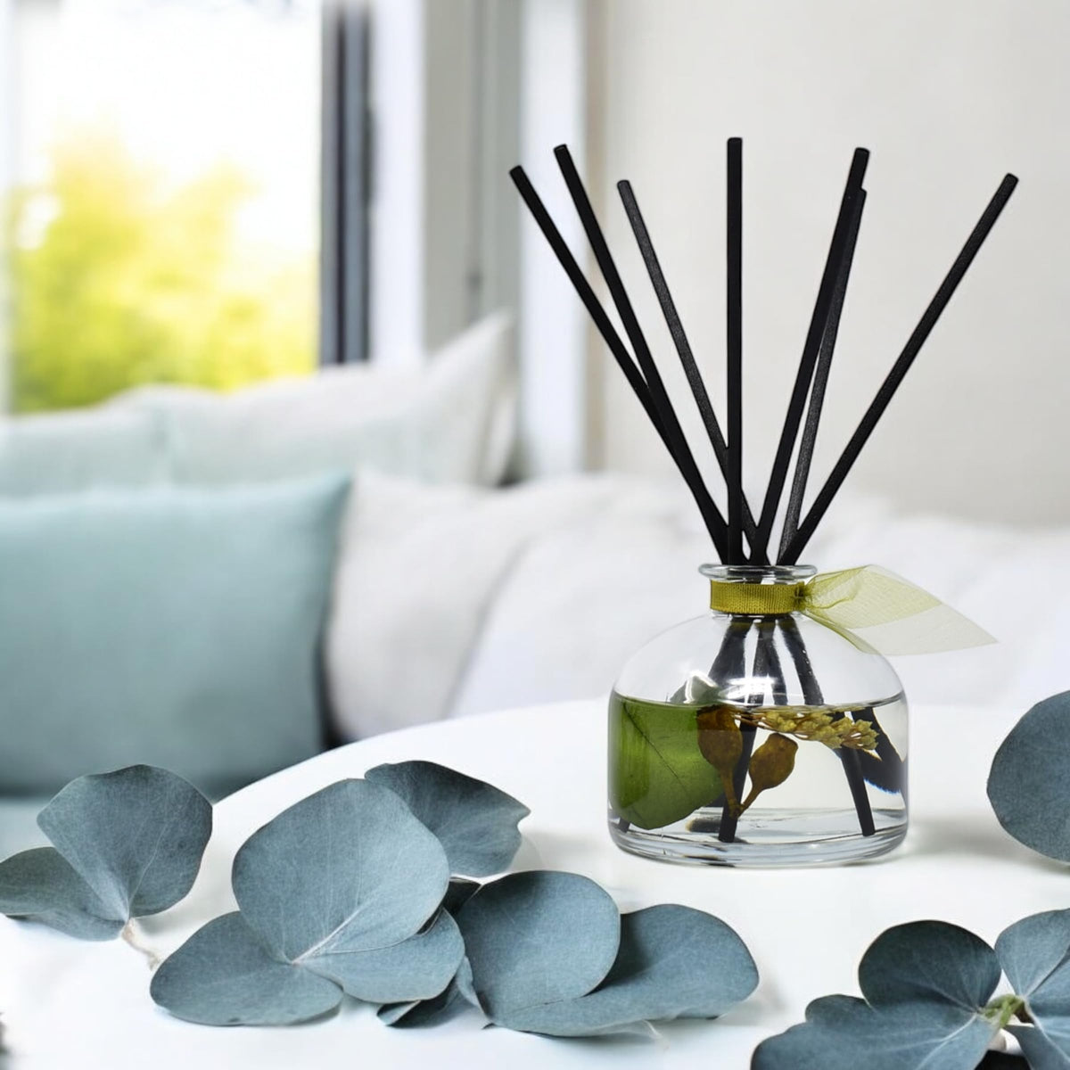 diffuser sitting on a bathroom shelf beside towels.