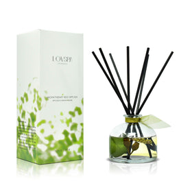 LOVSPA eucalyptus reed diffuser bottle with natural reeds displayed on a bathroom shelf.