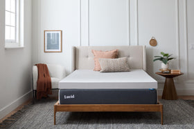 Lucid 4-inch bamboo charcoal memory foam topper in queen setup for plush comfort.