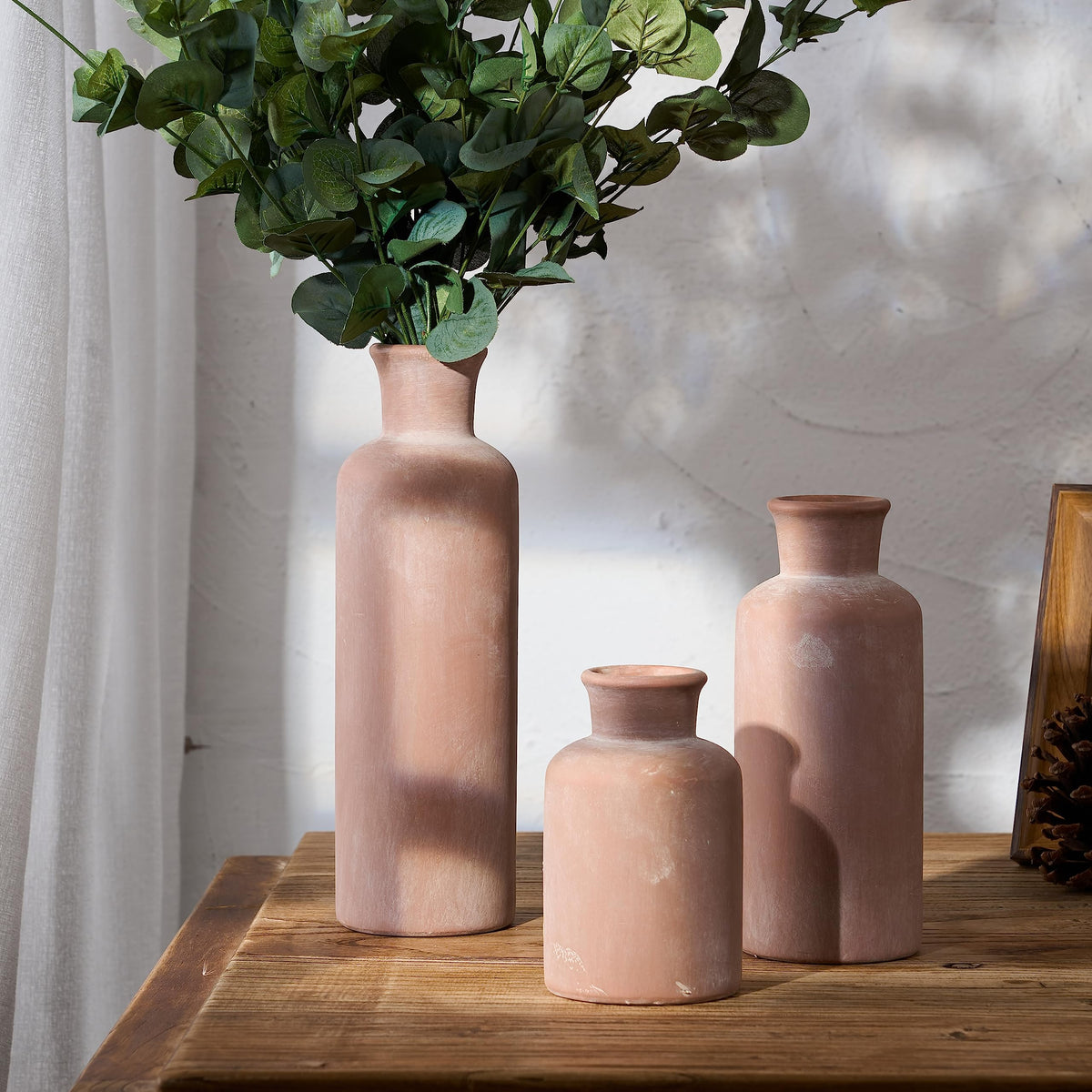 LUKA trio on a fireplace mantel adding rustic charm to the space.