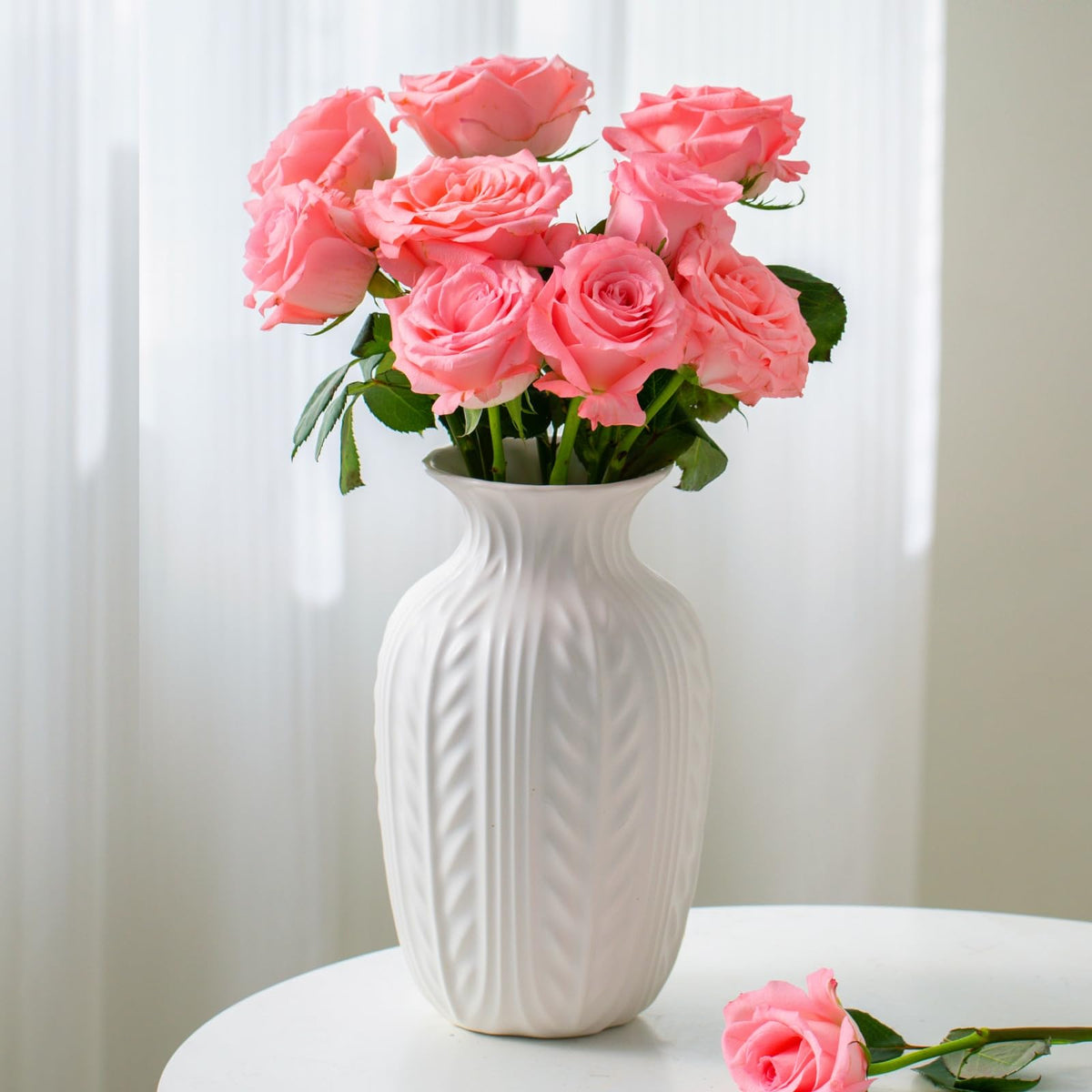 Lvases matte white vase with dried flowers in a bright entryway or living room