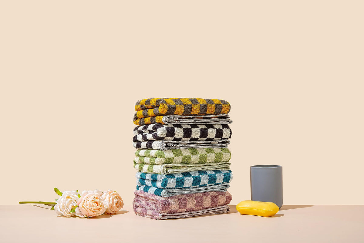 Madi-Cadi hand towels purple checkered design suitable for hotel-style guest rooms.