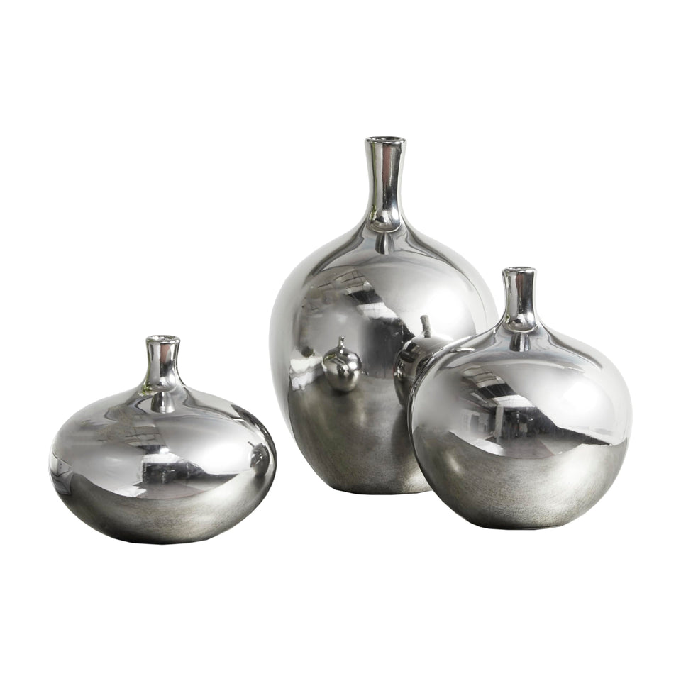 Madison Park Ansen ceramic vase with silver metallic finish illuminates shelves.