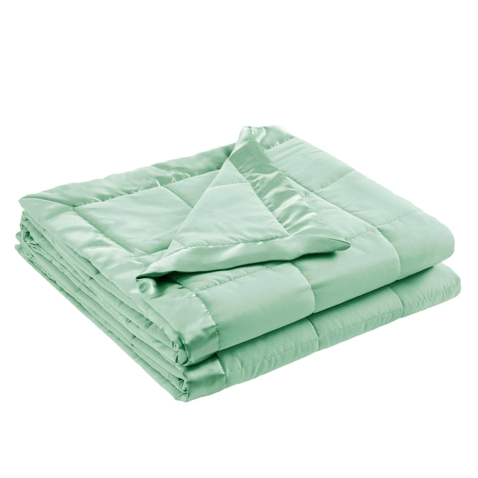 Madison Park Windom blanket seafoam on bed offers lightweight warmth