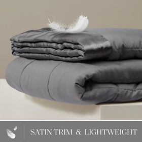 Madison Park Windom satin trim detail adds a luxurious touch to any bed.