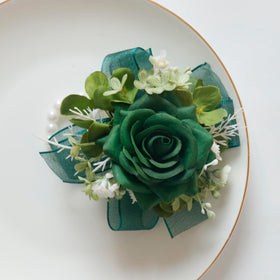 Boutonniere back with pins and clips for secure wearing