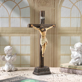 Magicsculp standing cross on tabletop adds warm faith-inspired decor to any room.
