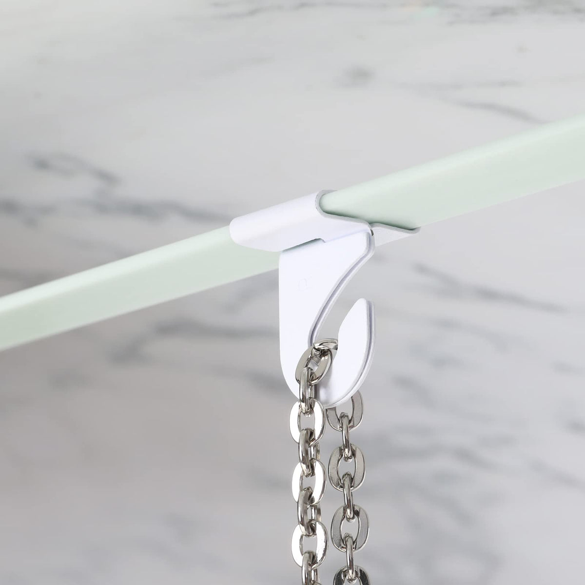 MAKALONE right and left ceiling hooks enable secure, adjustable hangs.